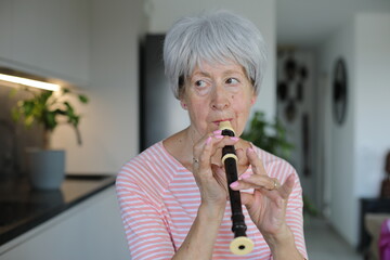Senior woman playing the flute