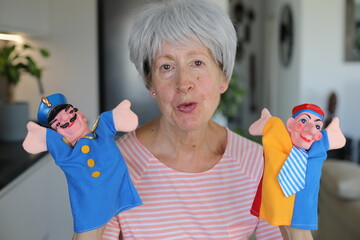 Senior teacher holding some cute puppets 