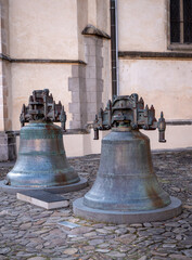 Obraz premium Old cracked historical bells: Ján from 1486 and Urban from 1584 at the Church of St. Aegis on the Town Hall Square in Bardejov.