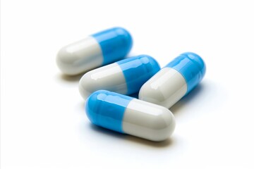 A group of blue and white pills on a white surface