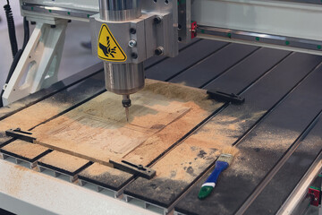 Cnc milling machine in work wood at the factory