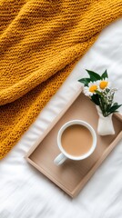 Enjoy a calming moment with a beautifully crafted cup of coffee nestled on a wooden tray, accompanied by a cozy blanket in a tranquil home setting