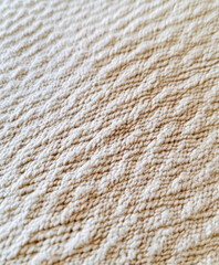 woven fabric texture made from organic cotton, intricate patterns, soft neutral tones, texture-rich and detailed