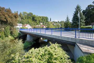 Reinforced concrete road bridge over the river. Close-up during sunny day in summer. Aerial view on...