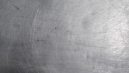 The steel plate surface has scratches from use.