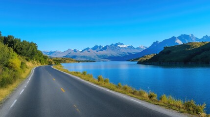 Idyllic Road Beside Lake with Majestic Mountain Views