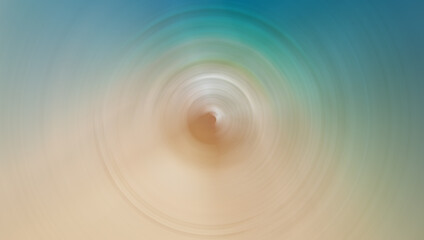 A blurred, circular motion effect image featuring soft tones of blue, green, and beige, resembling a serene abstract scene with a calming gradient.