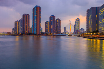 Fototapeta premium View of Tokyo at dusk from Eitai bridge. This is the Sumida River estuary and Tsukishima Cityscape with the Chuo Bridge , Chuo-Ku district in Tokyo, Japan.