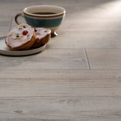 Coffee and Pastries on a Light Wooden Floor with Warm Natural Lighting