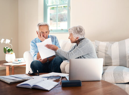 Frustrated, old couple and laptop for finance, bankruptcy and argument with gambling debt. Apartment, pc and documents with man, woman and home loan with inflation, upset and divorce with expenses - Powered by Adobe