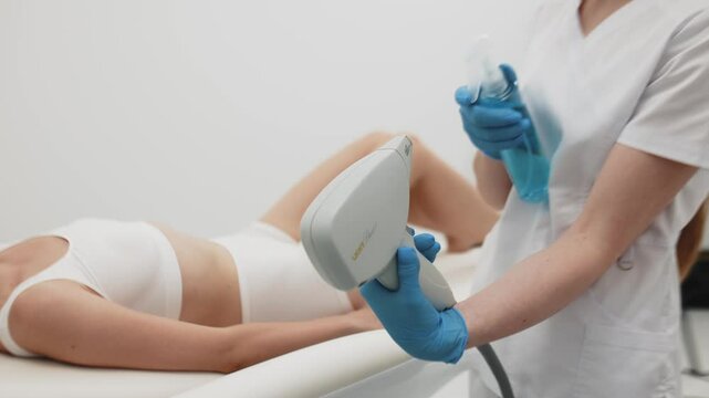 A professional cosmetologist meticulously disinfects a high-precision laser device for hair removal in a modern salon. Emphasizing safety, hygiene, and advanced skincare technology.