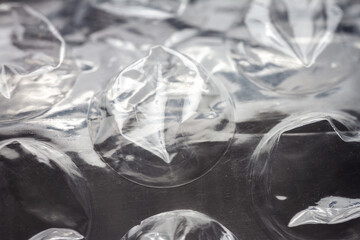 Extreme macro of plastic bubble wrap texture. Selective soft focus, shallow depth of field. Abstract dreamy background