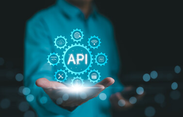API, Application Programming Interface Concept. A person presents a glowing API (Application...