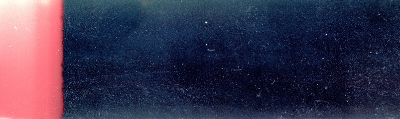 Blank grained film strip texture background with heavy grain, dust and light leak