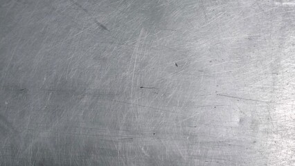 The steel plate surface has scratches from use.