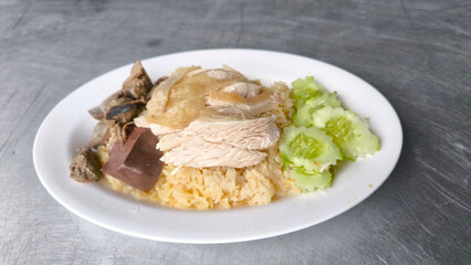 Chicken rice in a white plate on the dining table