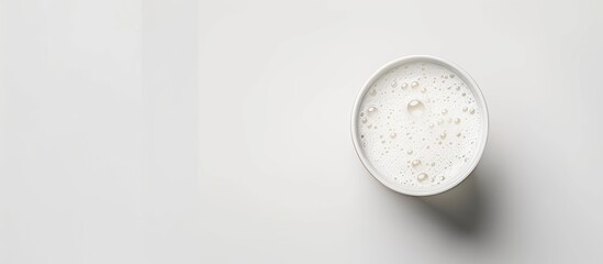 A glass of milk against a white background Top view Copy space Isolated