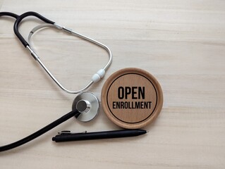 stethoscope and round wooden with words Open Enrollment. student registration