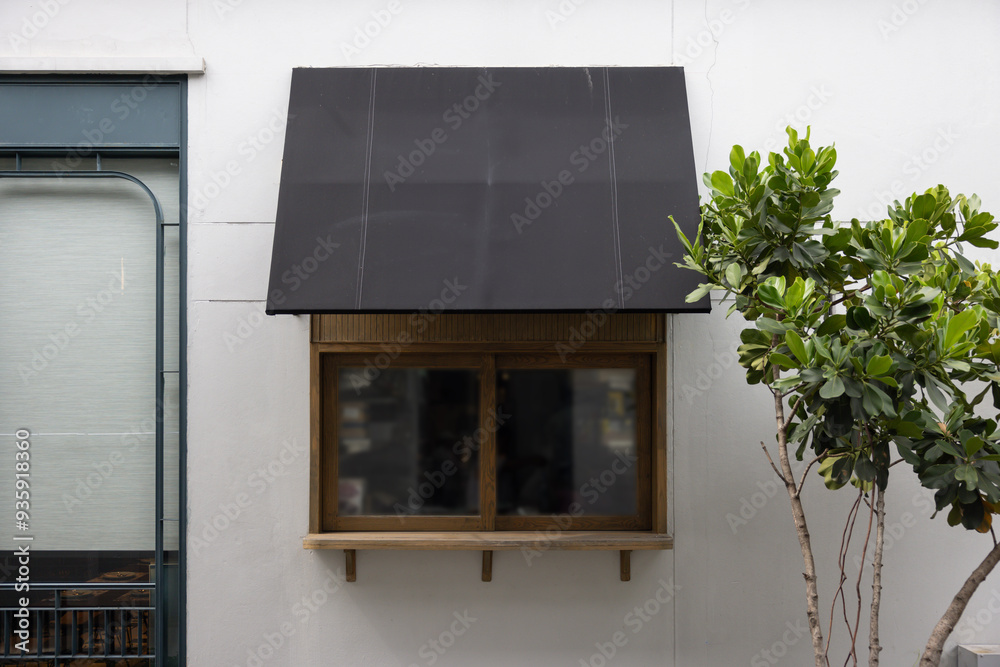 Poster a window with a black awning above it