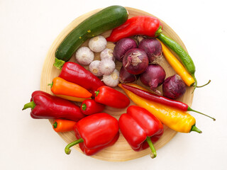 top-down view of a wooden plate filled with a variety of fresh vegetables