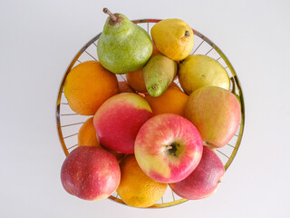 fruit basket with a variety of organic fruits on white background