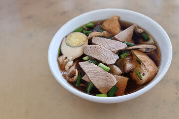 Bowl of kueh chap soup which is braised pork meat and organs, popular delicacy among the Chinese in Sarawak, Malaysia