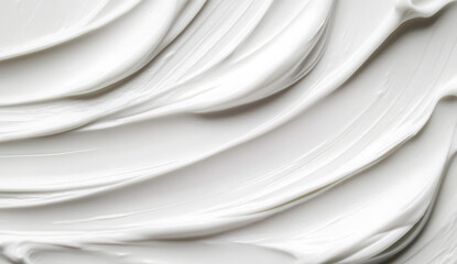 Close-up of smooth white cream texture with soft, flowing lines.