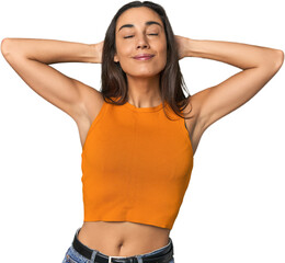 Hispanic young woman feeling confident, with hands behind the head.