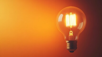Glowing vintage Edison light bulb against soft orange background, warm illumination, intricate filament detail, subtle wall texture, dramatic side lighting.