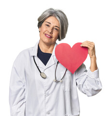 Caucasian mid-age doctor with heart symbol happy, smiling and cheerful.