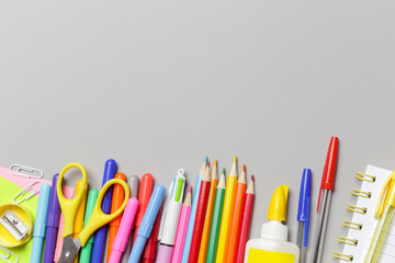 Back to school concept with variety of office and school supplies on grey background.	