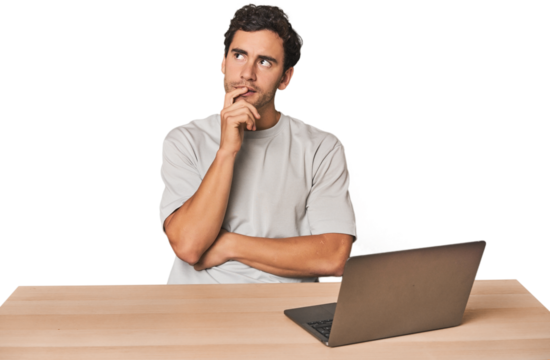Hispanic young man working on laptop looking sideways with doubtful and skeptical expression. - Powered by Adobe