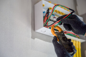 An electrical engineer or a closer-up electrician Install and check electrical switches and outlets...