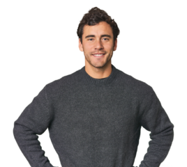 Young Hispanic man in studio confident keeping hands on hips.