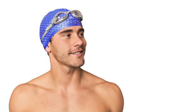 Close-up of Hispanic male swimmer with goggles, winner's attitude