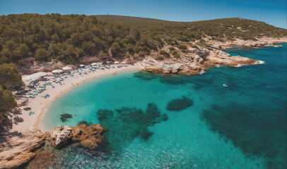 Fototapeta premium An aerial view of a secluded beach in a Mediterranean country, with clear blue waters, a sandy shore, and lush green trees in the background