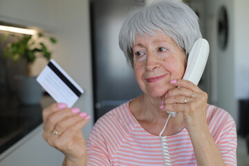 Patient senior woman talking with bank customer service about a problem with her credit card