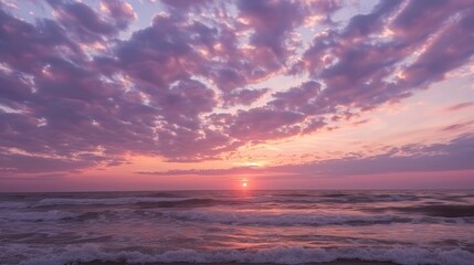 Obraz premium Dramatic Cloudscape Illuminated by Golden Sunset Over the Tranquil Sea, Capturing the Majestic Beauty of Nature with Vibrant Colors and Peaceful Reflections in a Serene Coastal Horizon
