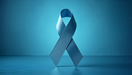 Blue awareness ribbon standing on reflective blue surface