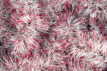 Close up of red tinsel garland. Ornament, abstract background