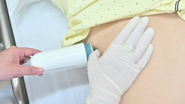 4K Close up a doctor hand runs ultrasound sensor over patient man liver