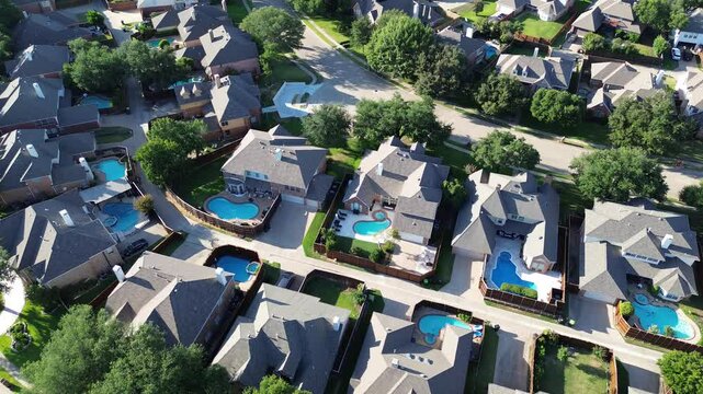 Swimming pool on almost every house at upscale residential neighborhood in Wentworth Estates, West Plano, suburbs Dallas Fort Worth metroplex, two story mansion home lush green trees, flyover