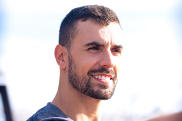 close-up smiling sporty man looking at camera outdoors.