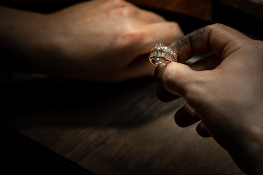 craftsman making diamond ring. hand made jewelery. Put diamond gem ring. diamond ring production craftman workshop. solitaire ring making