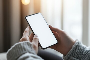 First person view of smartphone user looking at blank white mockup phone screen.