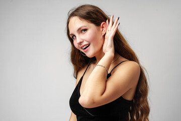 Fototapeta premium Young Woman With Long Brown Hair Listening Attentively in a Studio Setting.