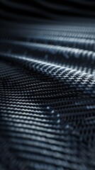 The elegant lines and patterns of a carbon fiber surface undulate, reflecting light and creating a striking visual interplay against a deep black backdrop, highlighting their modern aesthetic