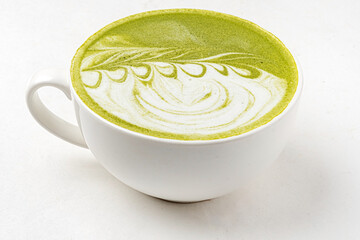 matcha latte in white cup on the white