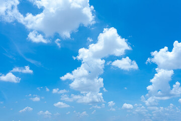 Bright blue sky with fluffy white clouds on a sunny day