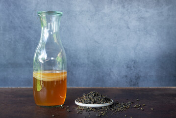 jars of kombucha and scoby healthy probiotic dink with oolong loose leave tea.